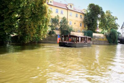 Prague: 1.5-Hour River Boat Cruise and Guided Tour - Boarding the river boat under Charles Bridge